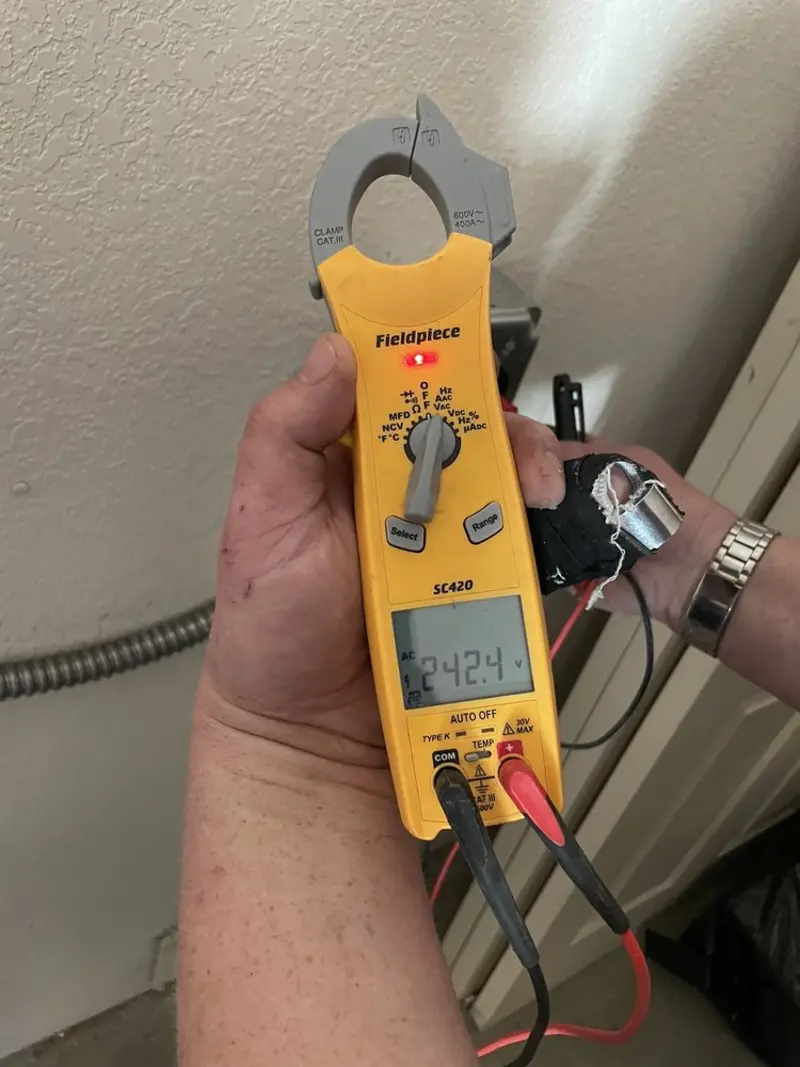 Voltage testing with clamp meter during Outlet Installation in Sheridan